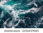 Small photo of Blue waves of water of the river and the sea meet each other during high tide and low tide. Whirlpools of the maelstrom of Saltstraumen, Nordland , Norway.