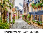 Beautiful view of scenic narrow alley with historic traditional houses and cobbled street in an old town in Europe with blue sky and clouds in summer with retro vintage Instagram grunge filter effect