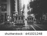 Classic view of historic traditional Cable Cars riding on famous California Street in beautiful morning light at sunrise in summer with retro vintage B&W filter effect, San Francisco, California, USA