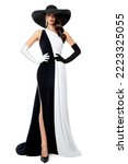 Small photo of Woman in Black and White Formal Dress. Fashion Model in Long Evening Contrast Gown. Elegant Lady in Black Hat and Gloves over Isolated Background. Chess Queen Concept