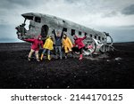 Funny friends posing near Solheimasandur Plane Wreck in Iceland