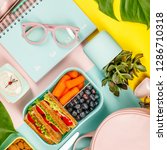 Small photo of Creative flat lay with healthy lunch and office or school supp