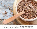 Lentils And Spoon In A Wooden...