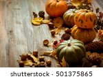 Small photo of Autumn decorative pumpkins, fall leaves on a rustic wooden background, natural fall style decorations. Natural plenteous border background vintage mock up.