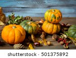 Small photo of Autumn decorative pumpkins, fall leaves on a rustic wooden background, natural fall style decorations. Natural plenteous border background vintage mock up.
