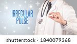Small photo of Close-up of a doctor giving a pill with IRREGULAR PULSE inscription, medical concept