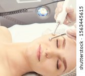 Small photo of Dermatology skin care facial therapy. Medical spa anto wrinkles procedure. Woman face rejuvenation. Pretty girl. Rf cosmetician equipment.