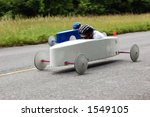 Two soap box derby cars speed...