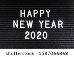 Happy New Year 2020 message displayed on a felt letter board.