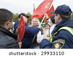 Small photo of RIGA, LATVIA, MAY 9, 2009: The Police preclude to use the forbidden symbols of Soviet Union at Celebration of May 9 Victory Day (Eastern Europe) in Riga at Victory Memorial to Soviet Army
