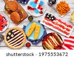 Fourth of July, patriotic, American themed food. Above view table scene on a white wood background.