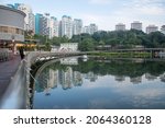 Small photo of Singapore- 23 Oct, 2021: People walks on the Pang Sua boardwalk on the Pang Sua Pond in Bukit Panjang, Singapore.building, sky, block, apartment, cityscape, estate, hdb