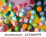 Colorful abstract geometric background with three-dimensional solid figures. Pyramid Dodecahedron prism rectangular cube arranged on colored paper.