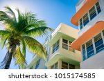 Typical colorful Art Deco architecture with bright backlit palm tree on Ocean Drive in South Beach, Miami, Florida