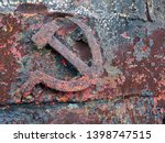Small photo of Rusted symbols of the Soviet Union. Hammer and sickle.