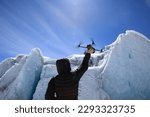Flying drone in high altitude glacier mountains