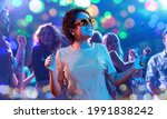 Small photo of leisure, clubbing and nightlife concept - smiling young african american woman in sunglasses dancing in ultraviolet neon lights over nightclub background