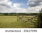 An Open Farm Gate Leading To A...