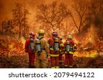 Small photo of Firefighters team battle a wildfire because climate change and global warming is a driver of global wildfire trends.