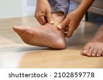 Senior Man Massage Foot With...