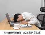 Small photo of Man with narcolepsy is fall asleep on office desk. Narcolepsy is a sleep disorder that makes people very drowsy during the day. .