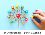 Business image of wooden tree with people icons over blue table, human resources and management concept