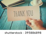 man hand holding card with the word thank you. retro style image