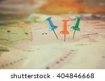 pins attached to map, showing location or travel  destination . retro style image. selective focus.