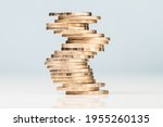Small photo of Inconsistency or unstable heap of coins could crash down any time, risk investment, uncertain financial status concept
