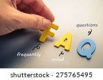 Hand arrange wood letters as FAQ abbreviation ( frequently asked questions )