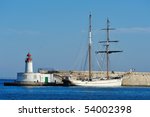 Lighthouse And Sailboat In The...
