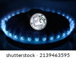Gas burner and ruble coin, Russian money on home gas stove. Blue propane flame and ruble currency. Concept of Russia and Europe economy, oil, cost, inflation, sanctions, Gazprom, embargo and crisis.