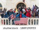 Small photo of Washington, DC - January 6, 2021: Pro-Trump protesters seen occupying balcony of Capitol building