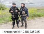 Small photo of Sappers Alexander and Mikhail clear land from possible landmines before workers fix power line destroyed during Russian invasion near village of Kamyanka of Kharkiv Region of Ukraine on May 10, 2023
