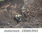 Small photo of Members of National Guards of Ukraine de-mining unit prepare unexploded munition for controlled destruction by explosion near Kherson in Ukraine on May 22, 2023