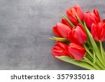 Red Tulips On A Wooden...