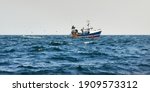 Small Fishing Boat Sailing In...