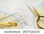 Small photo of Antique W HC 6" brass dividers calipers nautical navigation chart tool, parallel ruler, white map close-up. Vintage still life. Sailing, travel accessories. Planning, concept art
