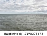 Muhu strait, Estonia, Baltic sea. Dramatic sky, storm clouds, water surface texture. Panoramic view. Nature, eco tourism, weather themes;
