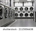 Row of industrial washing machines in a public laundromat