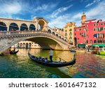 Colorful morning view of Rialto Bridge. Amazing cityscape of  Venice with tourists on gondolas, Italy, Europe. Romantic summer scene of famous Canal Grande. Traveling concept background.