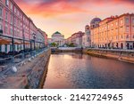 Spectacular summer sunrise in Trieste, Italy, Europe. Gorgeous morning view of Canal Grande di Trieste and Church of Sant'Antonio Nuovo on background. Traveling concept background.