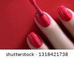 Red Finger nail point isolated red background with nail polish. Painting nails.