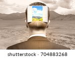 Back view of businessman with abstract open door and landscape view in head on desert background. Opportunity concept 