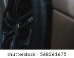 Stylish and expensive sports car closeup. Raindrops on a beautiful brown car. Black stylish sportcar alloy wheels with sports tires closeup