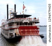 Small photo of New Orleans. USA. 09.24.03. Tourists on a Paddle Steamer on the Mississippi River at New Orleans in Louisiana in the United States of America.