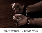Small photo of Handcuffed Male Hands in Restraint