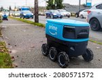 Small photo of Everett, WashingtonUSA - November 24, 2021: Autonomous delivery robot system Amazon Scout seen on a sidewalk delivering packages for Prime Members.