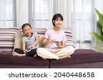 happy asian girl with sister... | Shutterstock . vector #2040448658