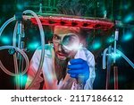 Portrait of a funny mad scientist conducting scientific experiments in the laboratory and looking at the camera through a magnifying glass. Fantasy, science fiction novel.